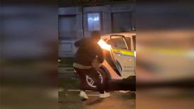 Garda car set ablaze amid Dublin violence